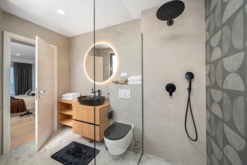 a bathroom with a shower with a toilet and a sink at Villa Marko Forever in Makarska