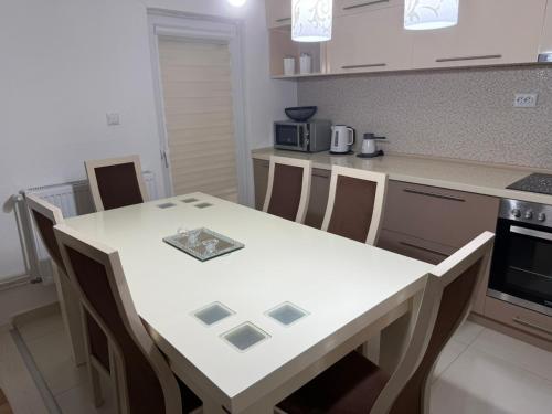 a kitchen with a white table and chairs in it at Villa Rina in Bitola