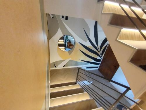 a spiral staircase with a circular window in a building at Vila Karlovčanka smeštaj u centru Sremskih Karlovaca in Sremski Karlovci