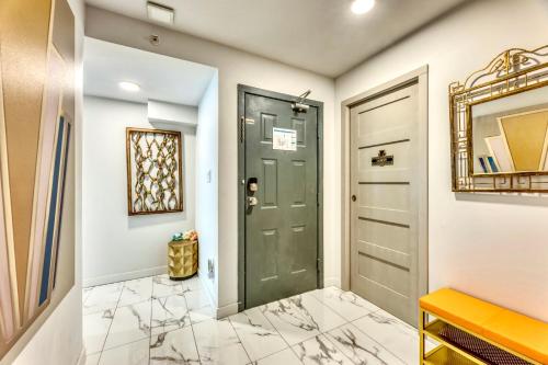 a hallway with a green door and a mirror at Art Deco Broadway Queen Room in Vancouver