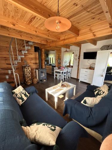 a living room with blue couches and a table at Monasteria in Stare Monasterzysko