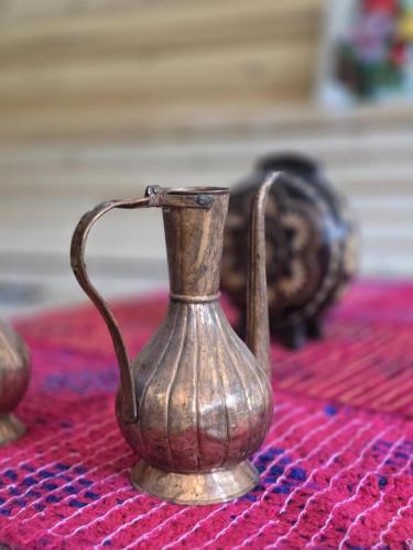 a small metal vase sitting on top of a table at Ekoo katun Jezerca in Vusanje