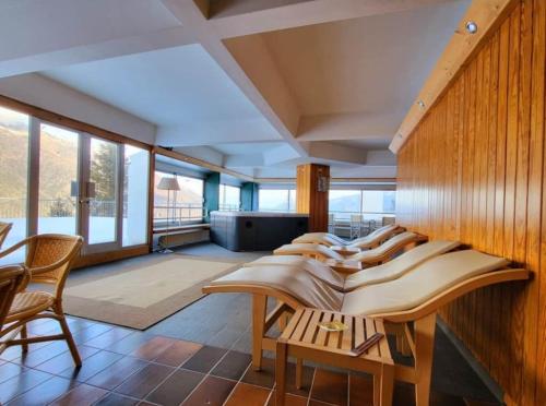 a room with a row of chairs and tables at Genziana Apartment in Marilleva