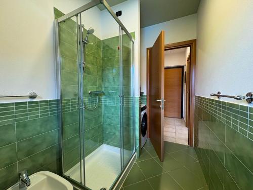 a bathroom with a glass shower and a toilet at Monolago pool & view in Arolo