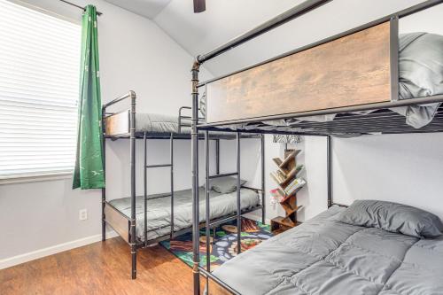 a room with two bunk beds and a bed at 14 Mi to Dtwn OKC Edmond Gem with Fenced Yard! in Edmond