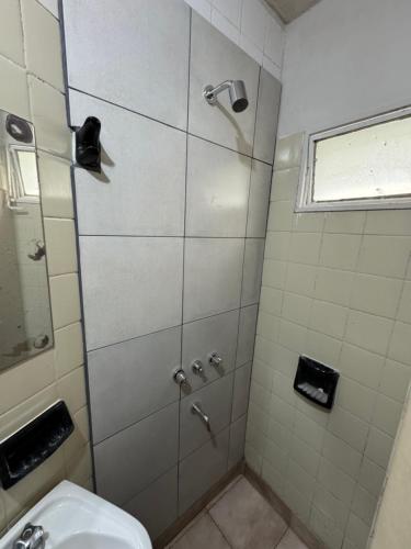 a bathroom with a shower with a toilet at Jujuy Hostel in San Salvador de Jujuy