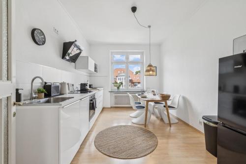 a kitchen with white appliances and a table in it at Altbaujuwel in Schwelm, nahe Köln,DO,Df 4 Pers in Schwelm
