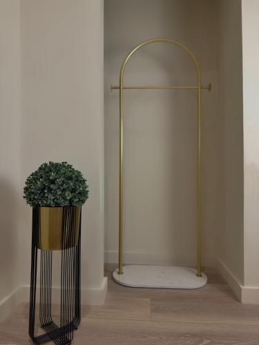 a vase with a plant in the corner of a room at 3 KING beds Free Parking Modern Luxe Escape in Pittsburgh