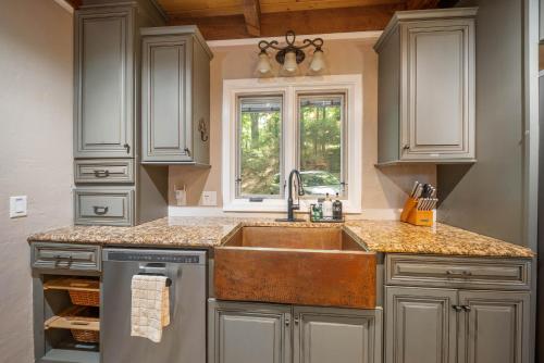 a large kitchen with a sink and a window at Lake Hills Hideaway in Wilkesboro