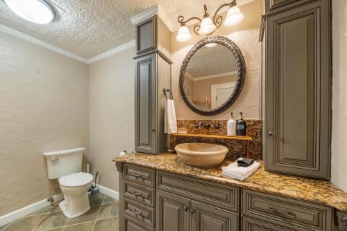 a bathroom with a bowl sink and a toilet at Lake Hills Hideaway in Wilkesboro