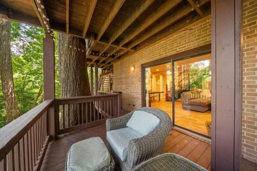 a porch with wicker chairs on a wooden deck at Lake Hills Hideaway in Wilkesboro