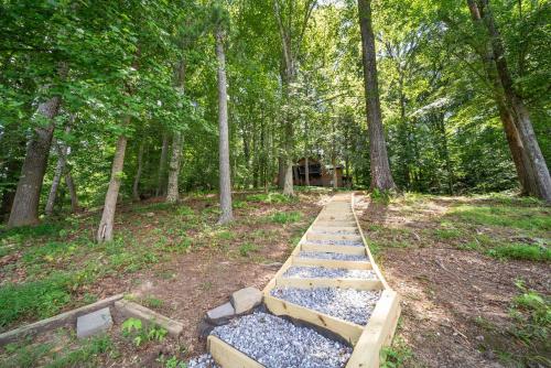 a wooden bench in the middle of a forest at Lake Hills Hideaway in Wilkesboro