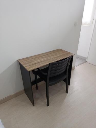 a wooden table with a chair at a desk at Maison individuelle Rosières-en-Santerre in Rosières-en-Santerre