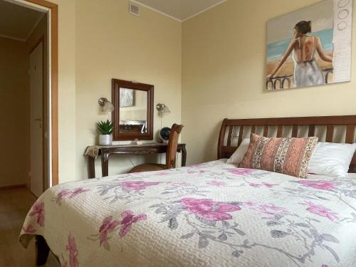 a bedroom with a bed and a table with a mirror at Akord Apartments with FREE PARKING in Pärnu