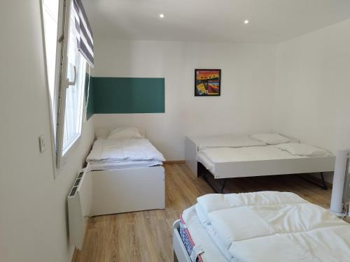 a room with two beds and a window at Gîtel'harmonie2 in Fraize
