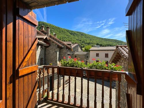 a balcony of a house with flowers on it at Apartamentos Lausan in Gavín