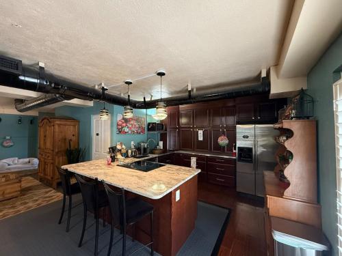 a kitchen with wooden cabinets and a island with a counter top at Cozy Retreat in the Heart of it all! in Brooksville