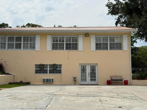 a house with a large driveway in front of it at Cozy Retreat in the Heart of it all! in Brooksville