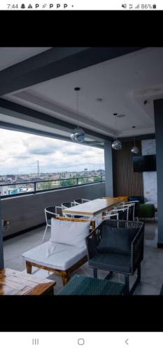 a balcony with a table and chairs and a view at villa Toscana GRA Port Harcourt in Port Harcourt