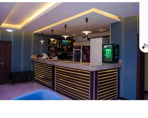 a bar in a restaurant with a tv on a counter at villa Toscana GRA Port Harcourt in Port Harcourt