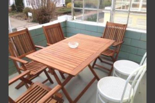 a wooden table and chairs sitting on a porch at Ferienwohnung Fritz in Zinnowitz