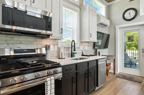 a kitchen with a stove and a sink at Pigeon Forge Landing RV Resort in Pigeon Forge