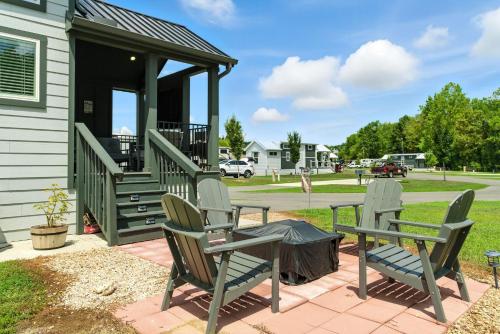 two chairs and a table on a patio with a gazebo at Pigeon Forge Landing RV Resort in Pigeon Forge