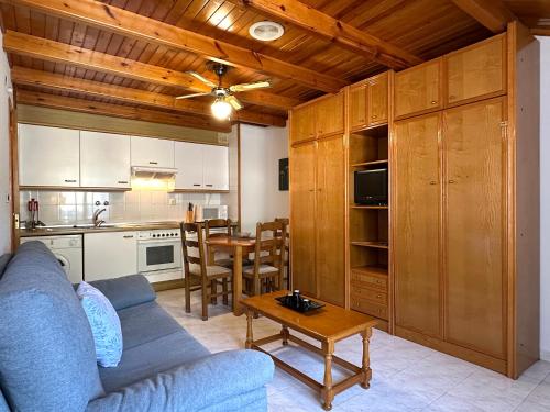 a living room with a blue couch and a table at Apartamentos Lausan in Gavín