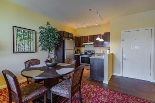 a kitchen and dining room with a table and chairs at Berkshire Mountain Lodge in Pittsfield