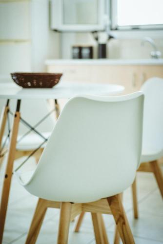 a white chair in front of a kitchen counter at Sea Breeze Rooms in Armenistis