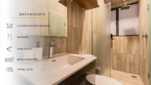 a bathroom with a white sink and a mirror at 205 Zocalo Cathedral 2bdrmB 2Bath fits 10 AC Apt in Mexico City