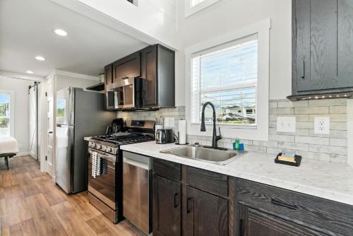 a kitchen with a sink and a stove at Pigeon Forge Landing RV Resort in Pigeon Forge