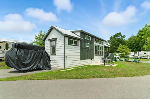 a tiny house with a tarp on the side of it at Pigeon Forge Landing RV Resort in Pigeon Forge