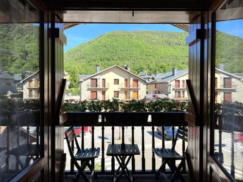a view from the window of a balcony with two chairs at Apartamentos Lausan in Gavín