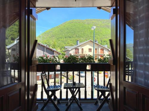a view from the balcony of a house with two chairs at Apartamentos Lausan in Gavín