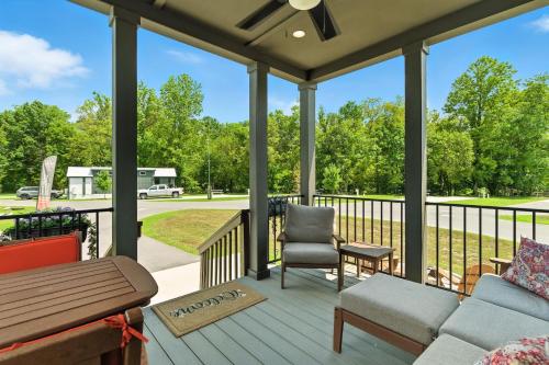 a screened porch with a couch and a chair at Pigeon Forge Landing RV Resort in Pigeon Forge