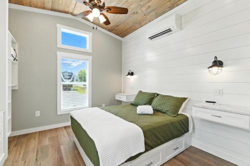 a bedroom with a bed and a ceiling fan at Pigeon Forge Landing RV Resort in Pigeon Forge