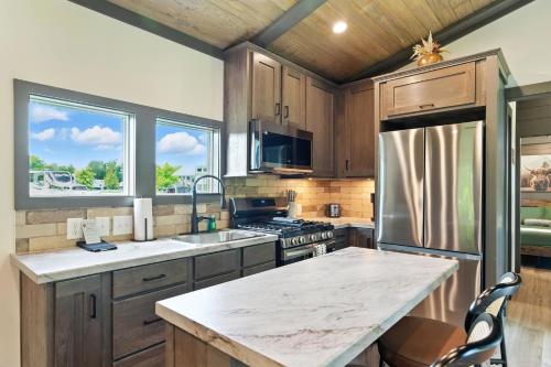 a kitchen with wooden cabinets and stainless steel appliances at Pigeon Forge Landing RV Resort in Pigeon Forge