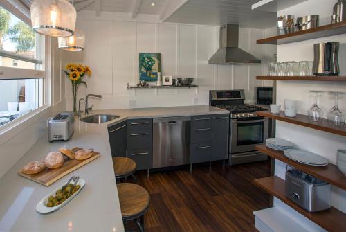 a kitchen with a counter with a plate of food on it at The Cottage at West Beach by Paradise Retreats in Santa Barbara