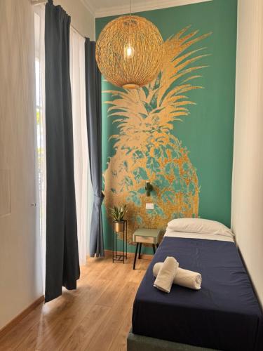 a bedroom with a bed and a pineapple wall at B&B Vitruvio Suites in Formia