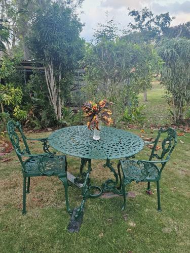 a table and two chairs with a vase on it at Dalkeith Greathouse in Knockpatrick