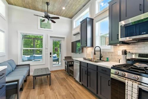 a kitchen with black cabinets and a blue couch at Pigeon Forge Landing RV Resort in Pigeon Forge