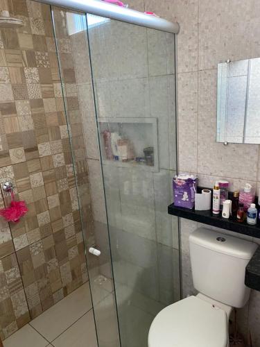 a bathroom with a toilet and a glass shower at Casa para COP30 in Ananindeua