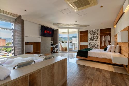 a hotel room with a large bed and a tv at Terra Biohotel in Medellín