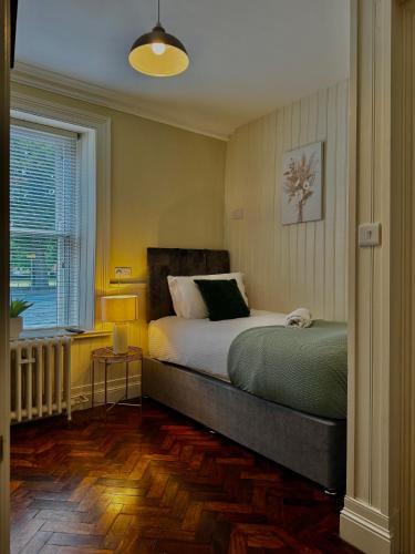 a bedroom with a bed and a window at Mallview cottage in Armagh