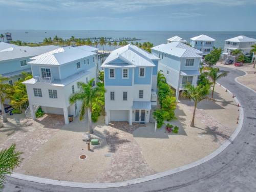 an aerial view of a row of houses on the beach at Emerald Tides - Luxury Oceanfront Home, Private Pool, 30' Dock in Marathon