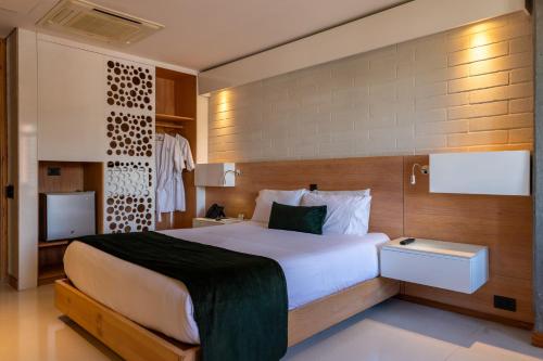 a bedroom with a large bed and a television at Terra Biohotel in Medellín