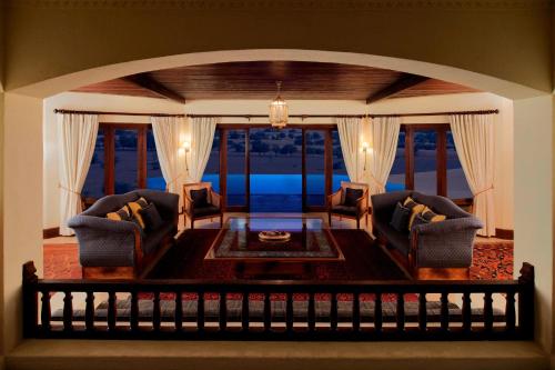 a living room with two chairs and a table at Al Maha, a Luxury Collection Desert Resort & Spa, Dubai in Murquab