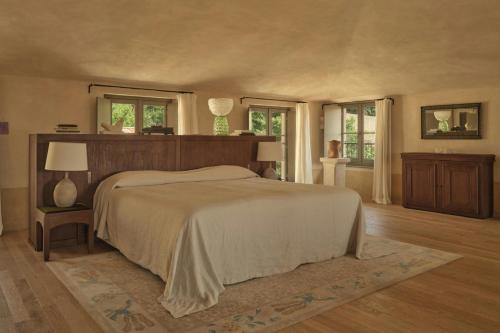a bedroom with a large bed and two windows at Hôtel du Couvent, a Luxury Collection Hotel, Nice in Nice