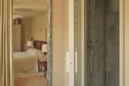 a bathroom with a shower and a bedroom with a bed at Hôtel du Couvent, a Luxury Collection Hotel, Nice in Nice